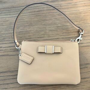 COACH, small cream/tan wristlet with bow.